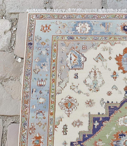 Terracotta Oushak wool rug with light blue floral patterns and intricate hand-knotted design