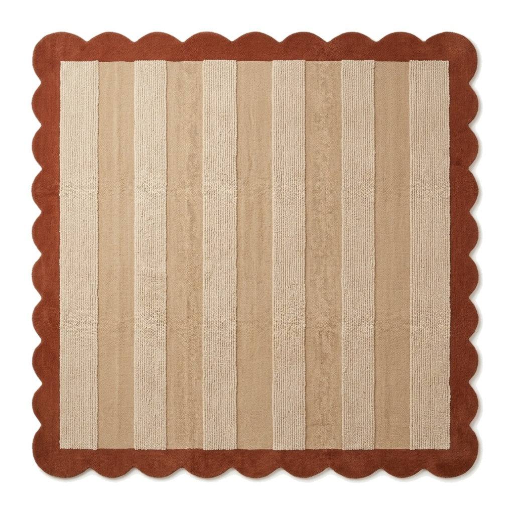 Terracotta & Sand Striped wool rug with alternating cream and beige bands, framed by a rust terracotta scalloped border.
