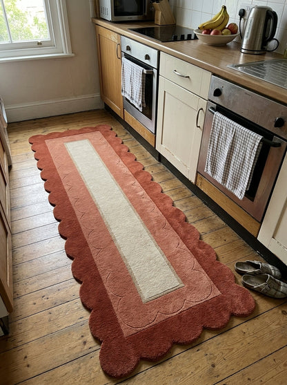 Terracotta Scalloped Runner Rug with a rust wool border, lighter terracotta carved scallops and a sand-coloured centre