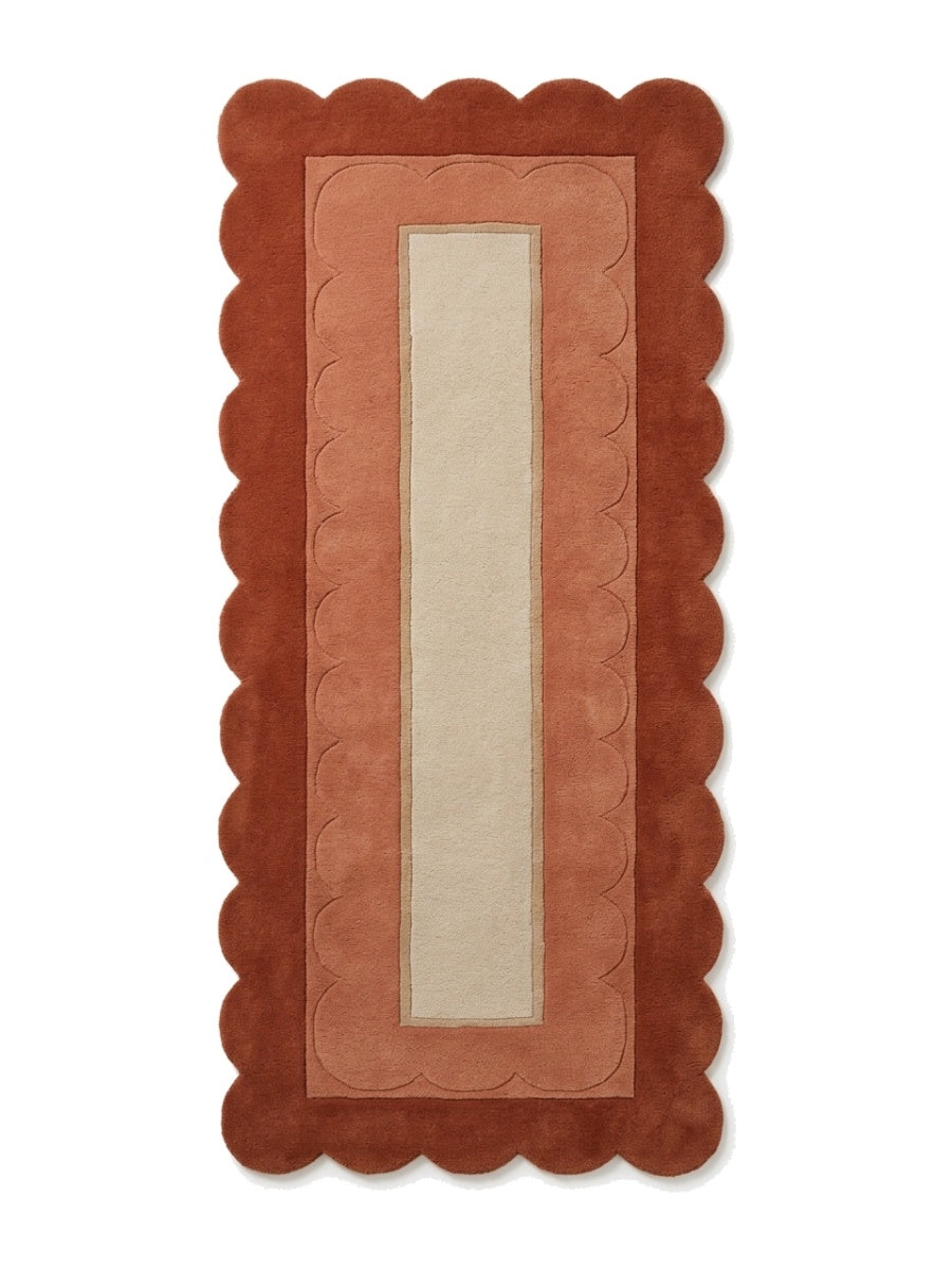 Terracotta Scalloped Runner Rug in rust and terracotta wool with a sand centre panel and carved scallop border