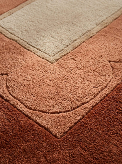 Terracotta Scalloped Runner Rug in textured wool, with a sand centre, layered rust tones and carved scalloped borders