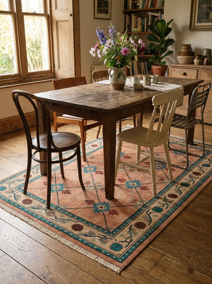 Terracotta Teal Trellis Hand Knotted Wool Area Rug in faded coral wool, with teal floral medallions, ivory border and fringe.