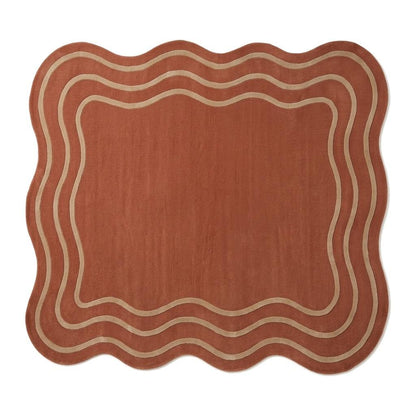 Terracotta Wavy Rug in rust with a soft wool appearance, irregular scalloped edges and cream wavy border lines