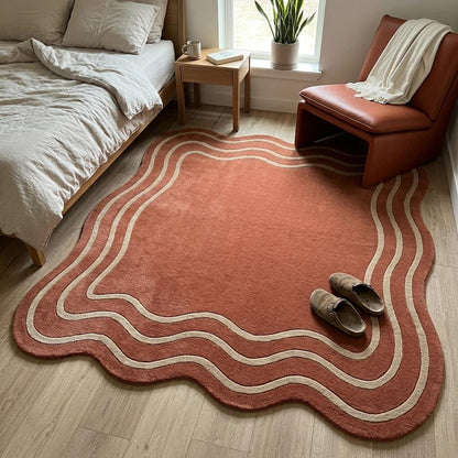 Terracotta Wavy Rug in plush rust wool with an irregular rippled edge and flowing cream wave lines.
