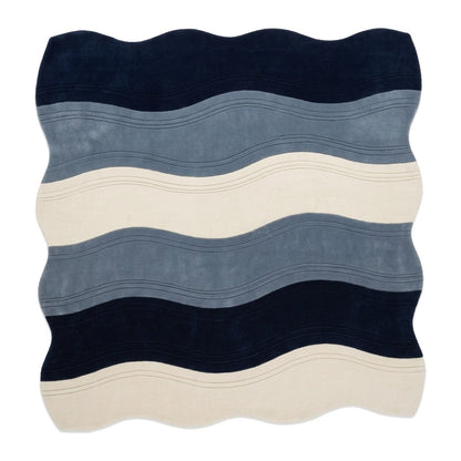 Wavy Rug with an irregular edge, featuring plush wool bands of navy, slate blue and ivory with fine carved lines