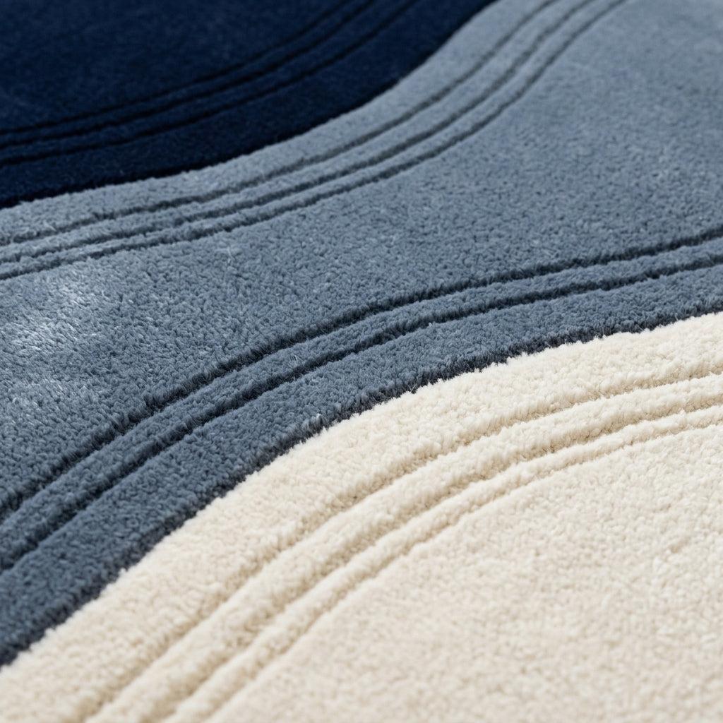 Wavy Rug with plush wool pile in navy, slate blue and ivory, featuring flowing bands and carved wave lines