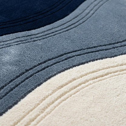 Wavy Rug with plush wool pile in navy, slate blue and ivory, featuring flowing bands and carved wave lines
