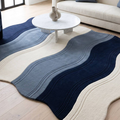 Wavy Rug in plush wool with irregular edges, flowing navy, slate blue and ivory bands and carved wave lines