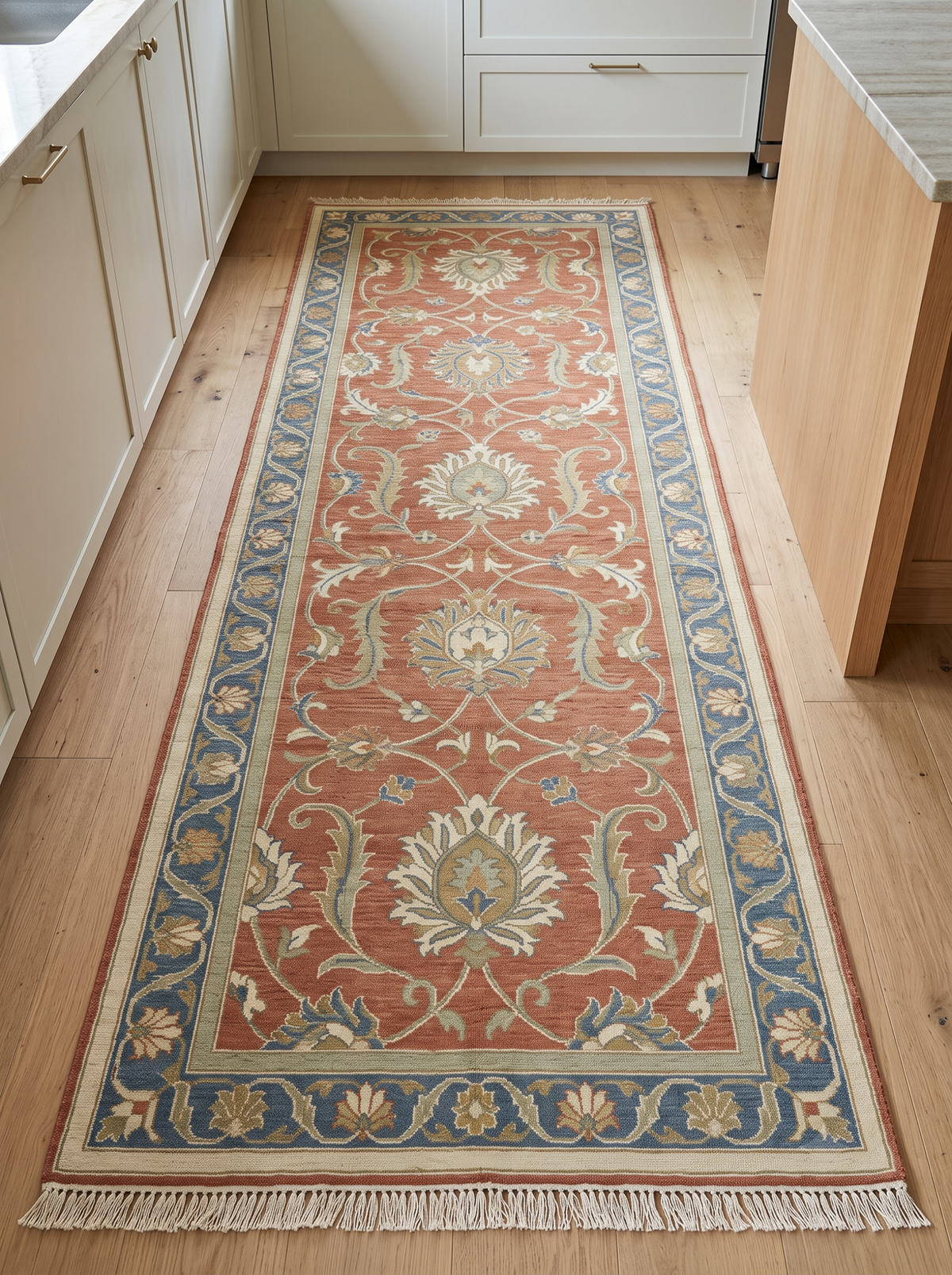 Hand Knotted Oushak Runner Rug in terracotta wool, with ivory floral vines, sage details, blue border and fringe.